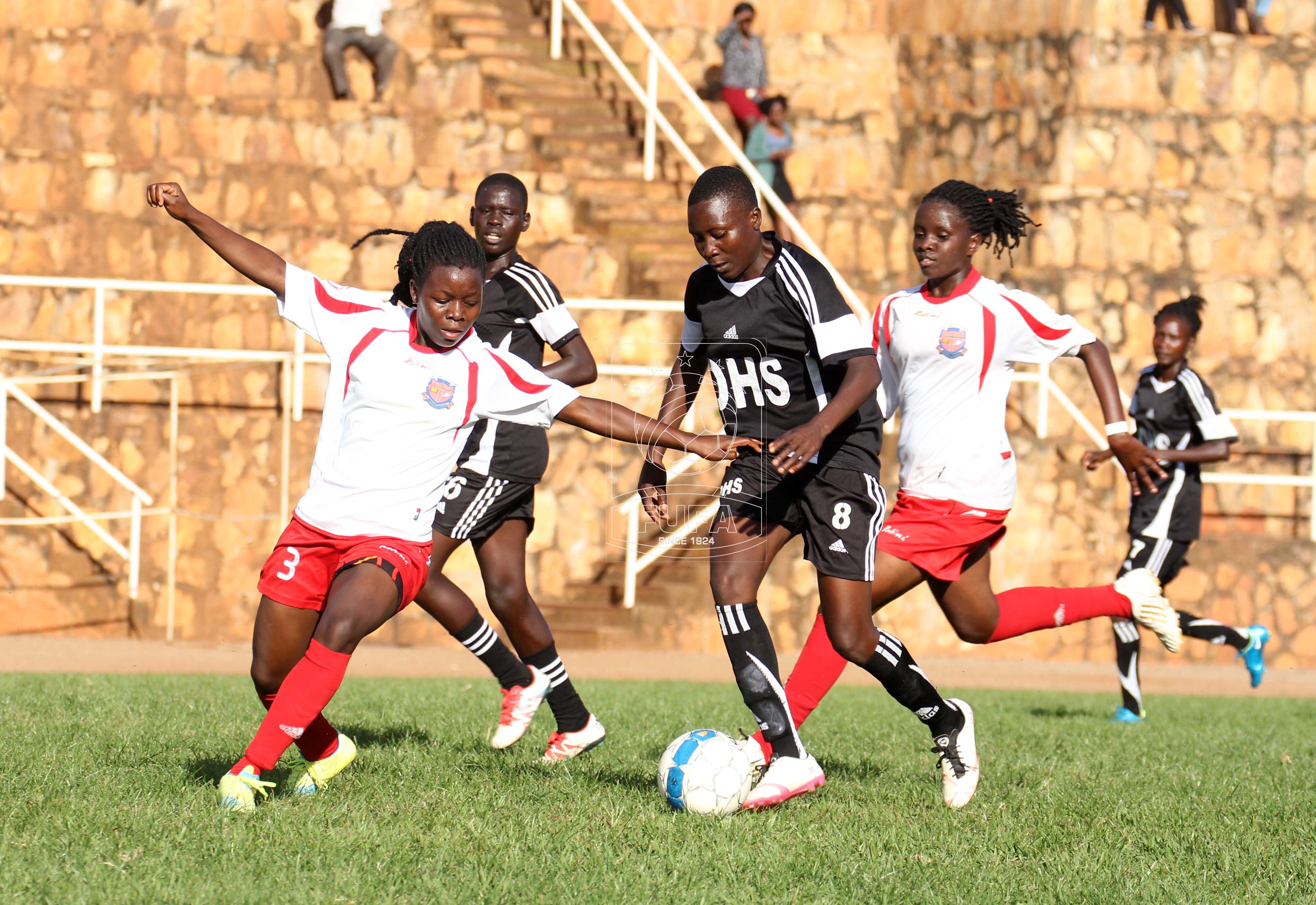 Amoding Siporosa (8) of Olila Women's FC taking on Mercy Nabulobi (3) of UCU Lady Cardinals