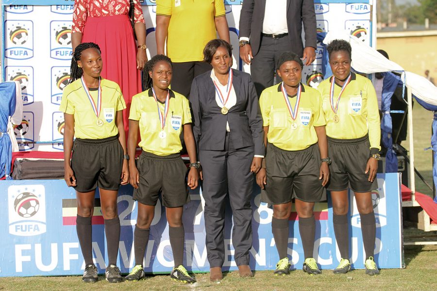 The referees with the assessor Rosebell Rwamuyamba (in suit) after officiating at the 2018 FUFA Women Cup Final