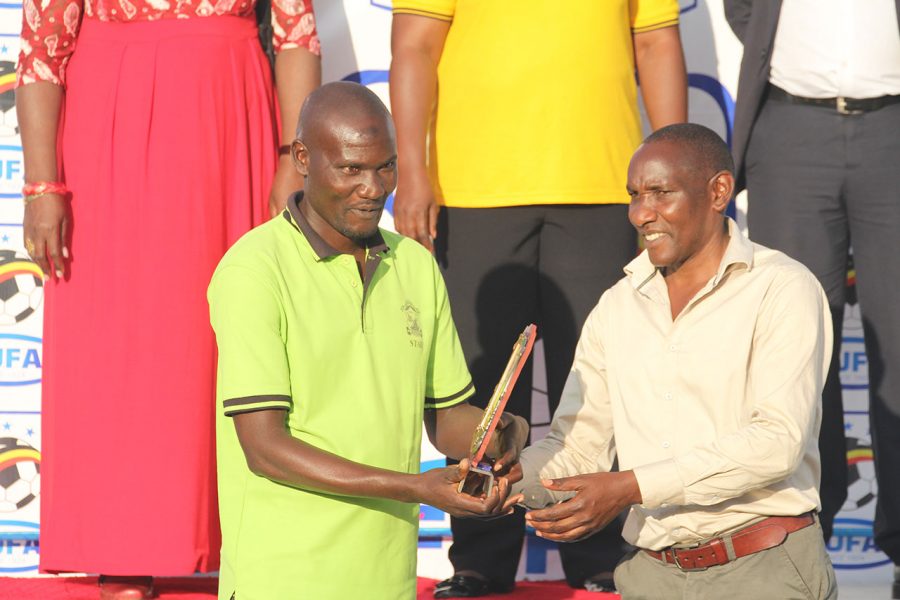 Bugiri Town View Official receives the Fair play Accolade from Western Region Football Association Chairman Sseka Mutaka